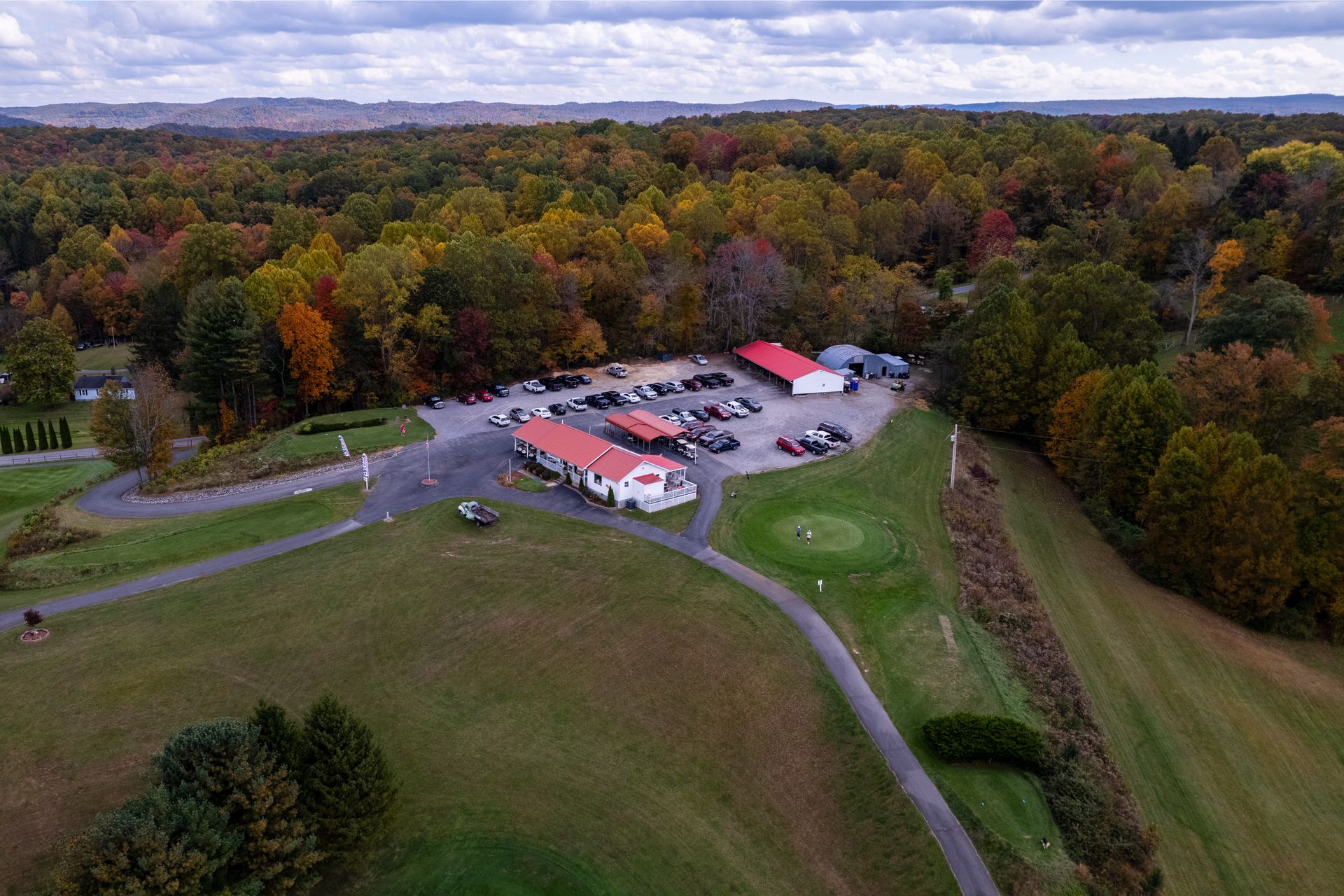 An aerial view of Bridge Haven Golf Club with a parking lot full of cars